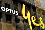 Signage on a store window reading "OPTUS YES"
