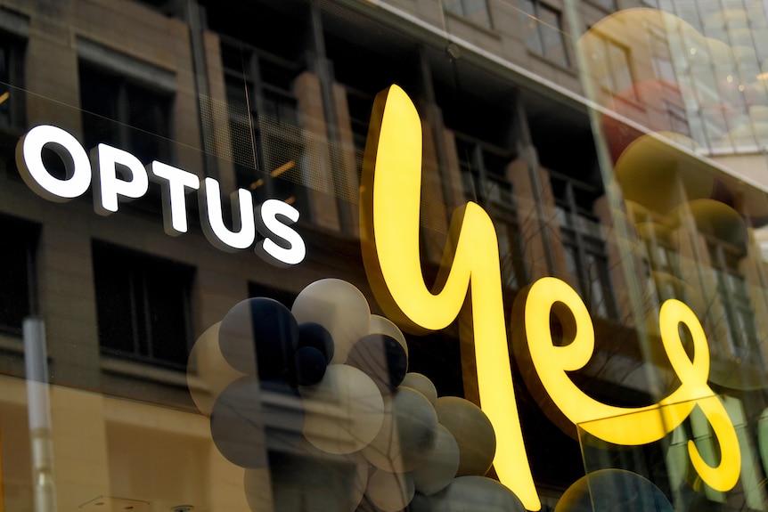 Signage on a store window reading "OPTUS YES"