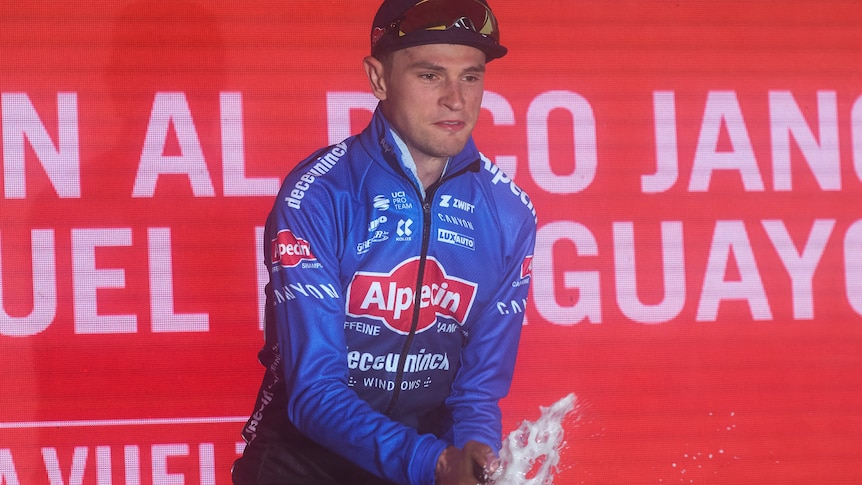 Australian cyclist Jay Vine sprays champagne after winning stage six of the Vuelta.