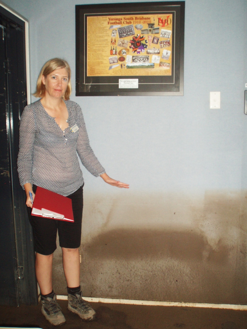 Nicole Johnston, Councillor for Tennyson Ward in Brisbane, shows the flood damage in her council ward office at Fairfield.