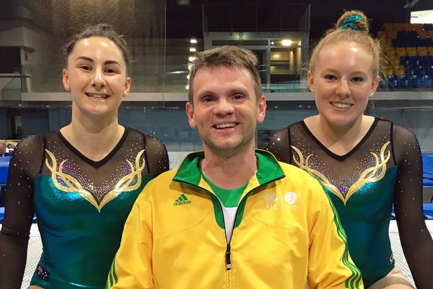 Trampoline athletes Claire Arthur and Cassie Hoare with their coach Viktor Zhuravlev.