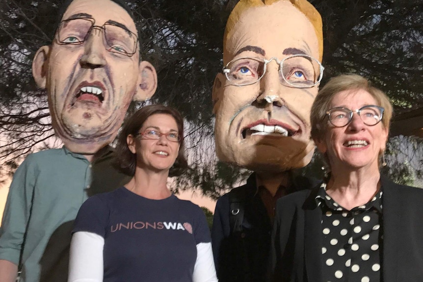 Meredith Hammat and Stephanie Mayman with paper mache heads of former political figures