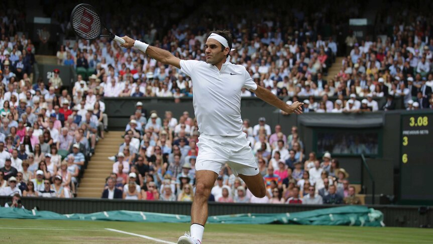 Roger Federer hits a backhand return to Marin Cilic at Wimbledon