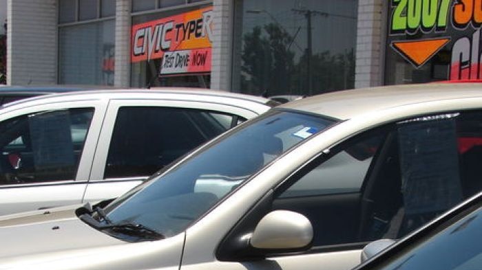 Cars parked at a dealership.