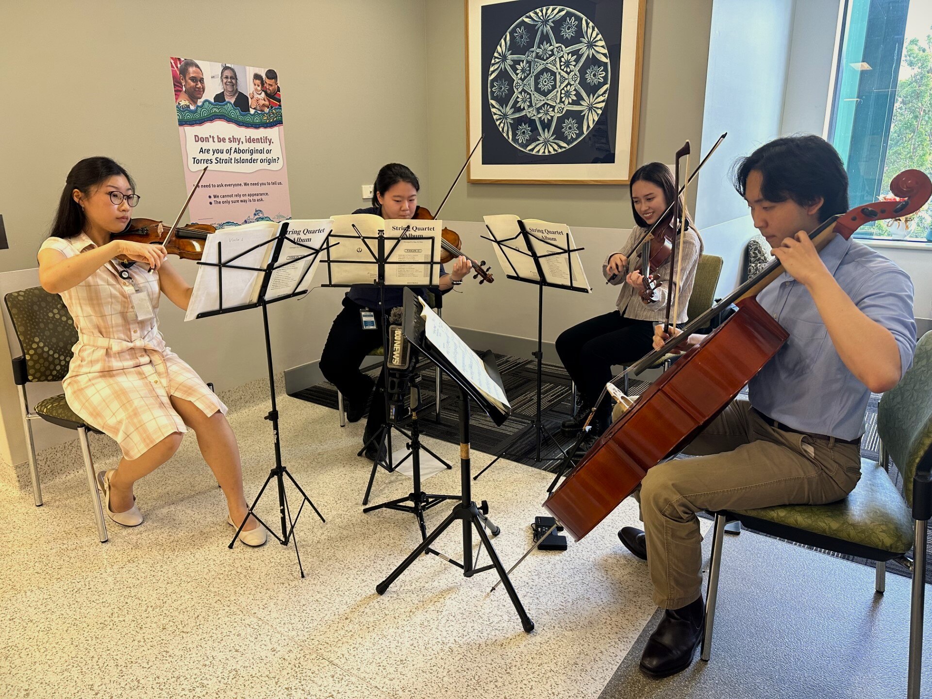 A string quartet perform on a hospital ward
