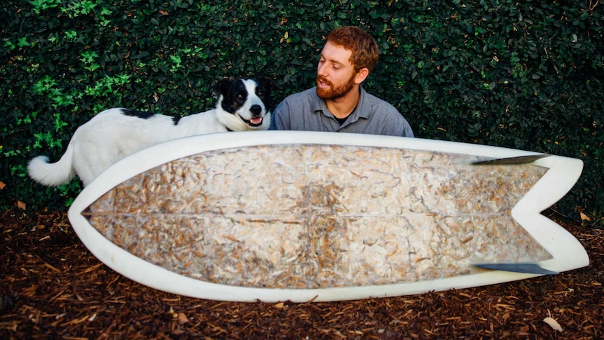 Taylor Lane with the surfboard made with cigarette butts