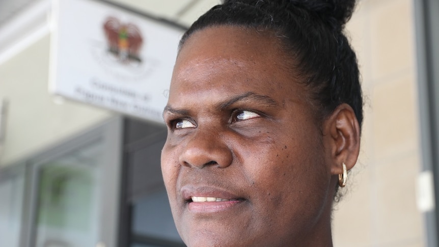 Close up of  Bougainvillean woman looking off into distance outside Papua New Guinean consulate in Cairns