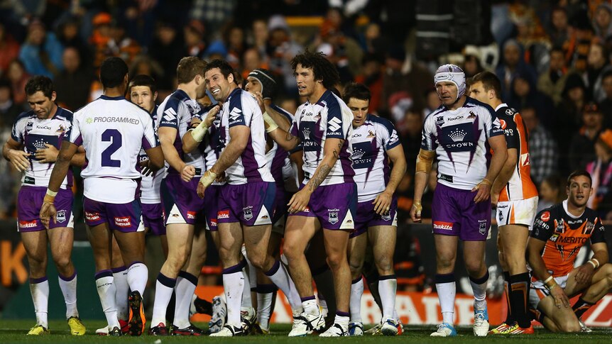 Melbourne players celebrate putting another try on Wests Tigers in their 26-6 win in round 26.
