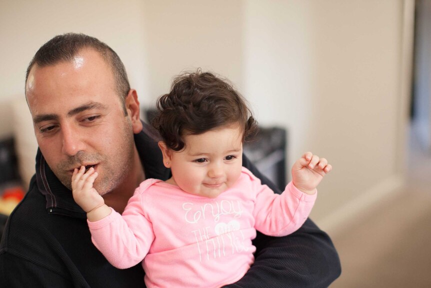 Mano Derboghossian holds his daughter Hasmig on his lap