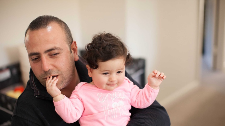 Mano Derboghossian holds his daughter Hasmig on his lap