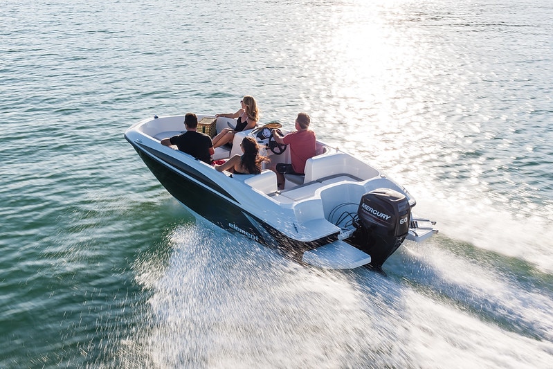 A group of people on a boat in open waters.