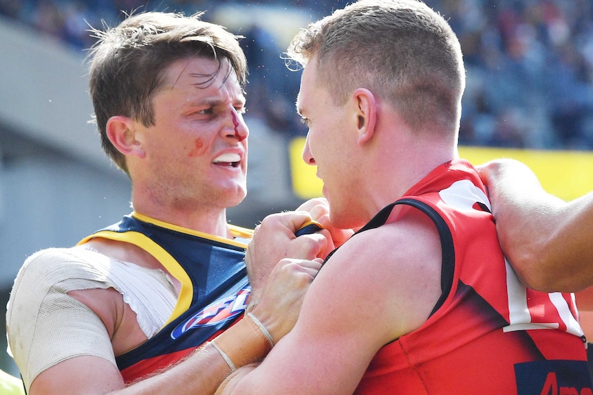 Matt Crouch bleeds from between his eyes as he grapples with Jacob Townsend