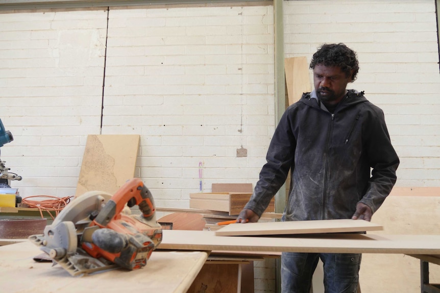 Phillip Gorey works on a cupboard in the men's shed.