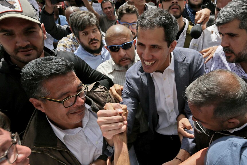 Juan Guaido surrounded by supporters.