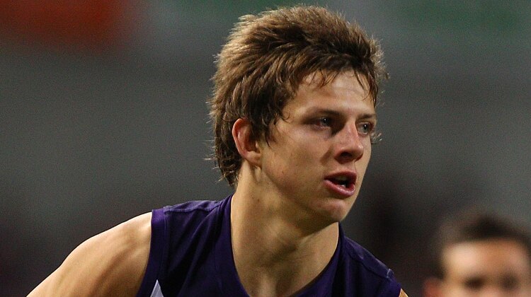 Fremantle player Nathan Fyfe about to kick the ball