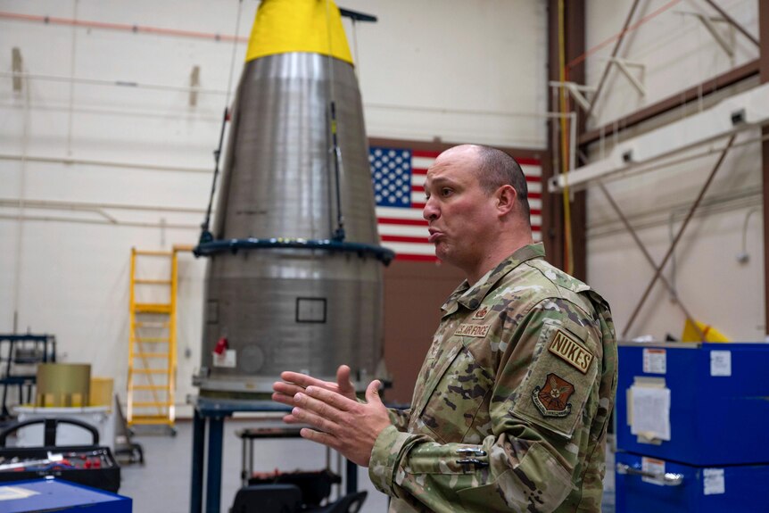 Chief Master Sergeant Andrew Zahm speaks in uniform next to a ballistic missile