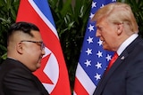 US President Donald Trump shakes hands with North Korea leader Kim Jong-un.