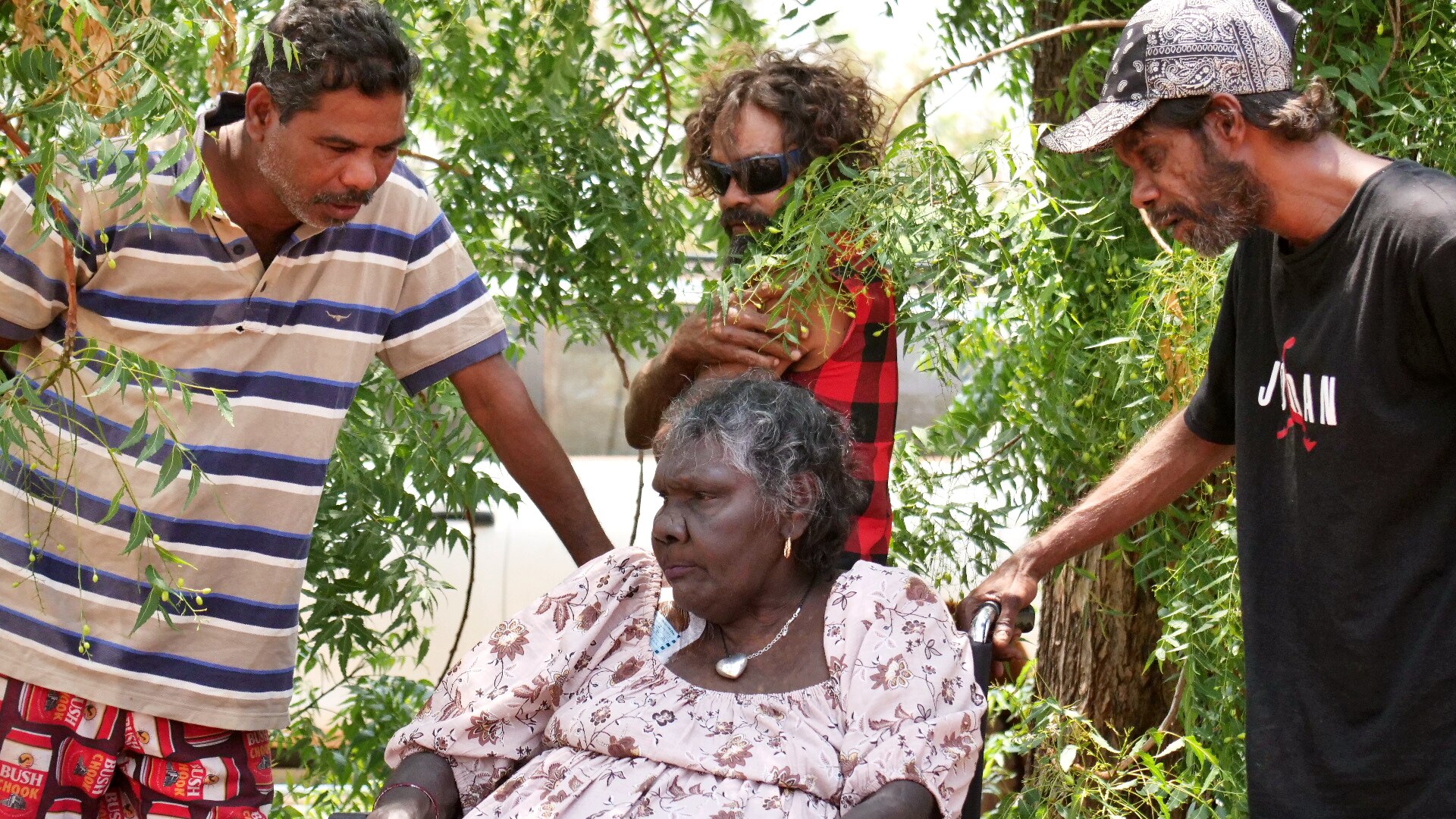 Tootsie Daniel with three men from the Roebourne community under tree