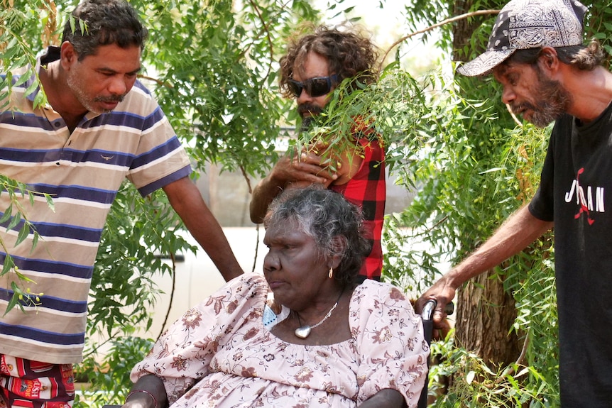 Tootsie Daniel with three men from the Roebourne community under tree