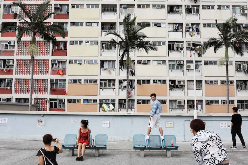 Hong Kong high rise apartments with people posing for pictures in front