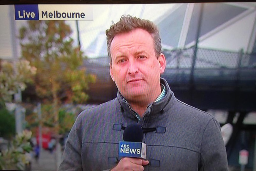 ABC reporter Matt Brown looks into the camera for a live cross.