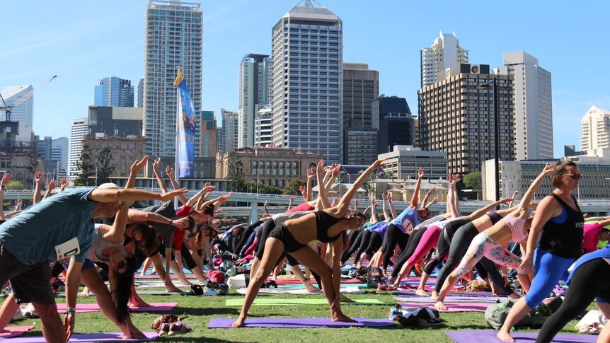 Thousands stretch out in yoga