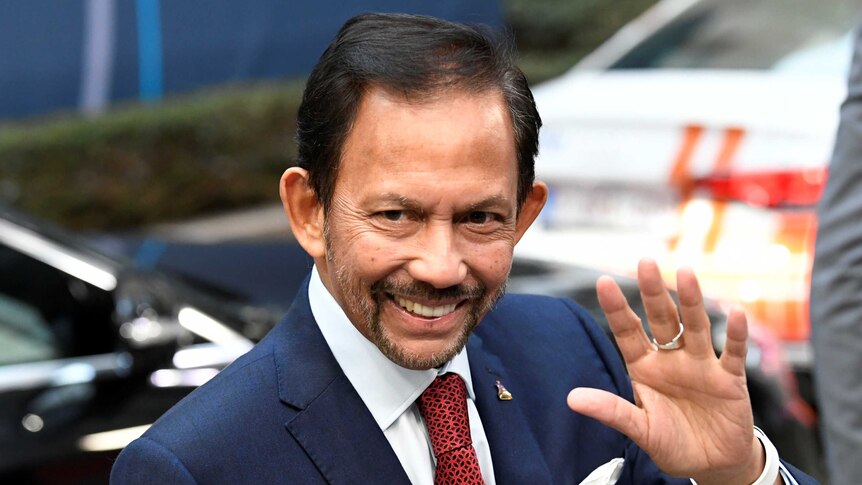 Sultan of Brunei Hassanal Bolkiah smiles and waves