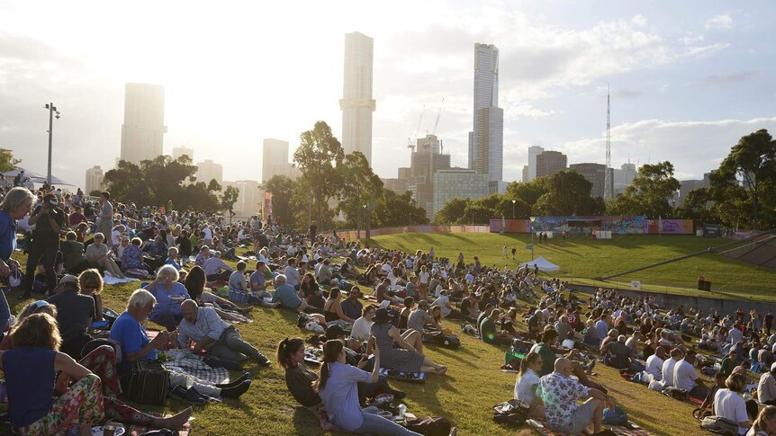 Audience members enjoying the afternoon sun on the hill at the Sidney Myer Music Bowl MSO Free Concert Series.