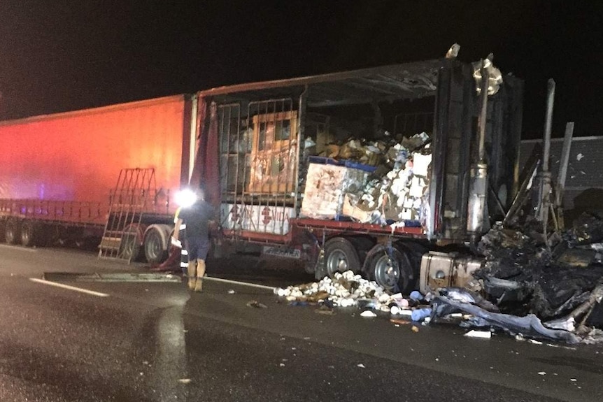 A blackened cab of a B-Double truck parked on the side of the road