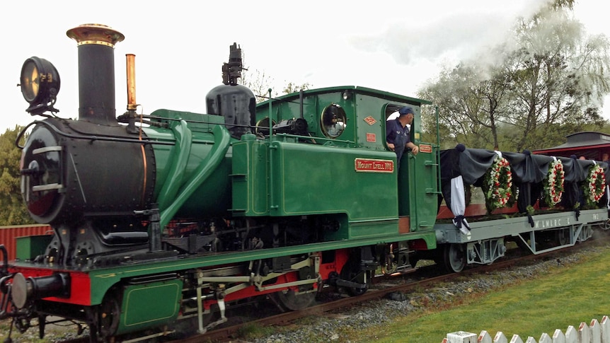 A steam train re-enacts the funeral procession for miners killed at Queenstown in 1912.