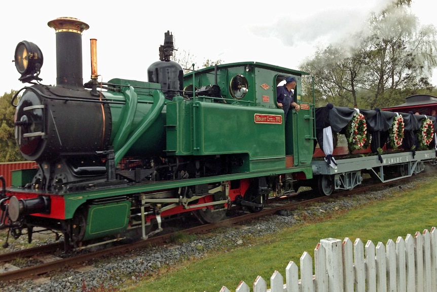 A steam train re-enacts the funeral procession for miners killed at Queenstown in 1912.