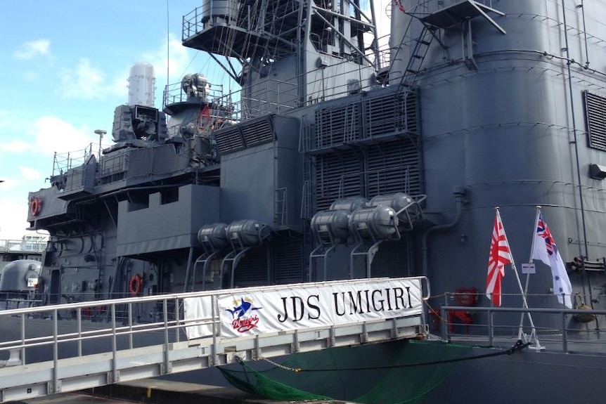 Japanese ship docked with ramp outstretched