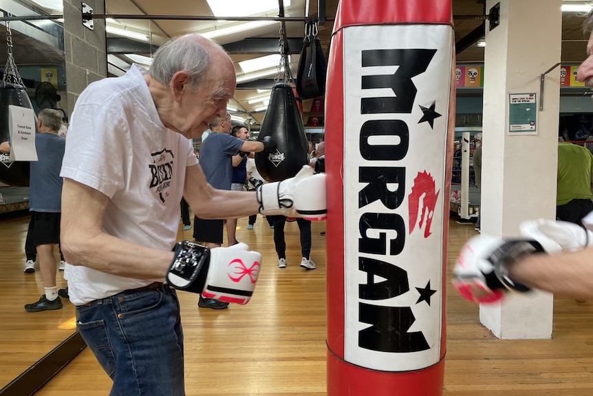 Older man with Parkinson's at a punching bag