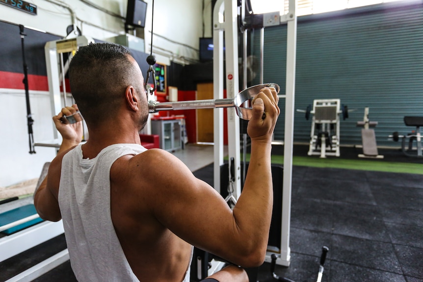 Peter on a weightlifting machine.