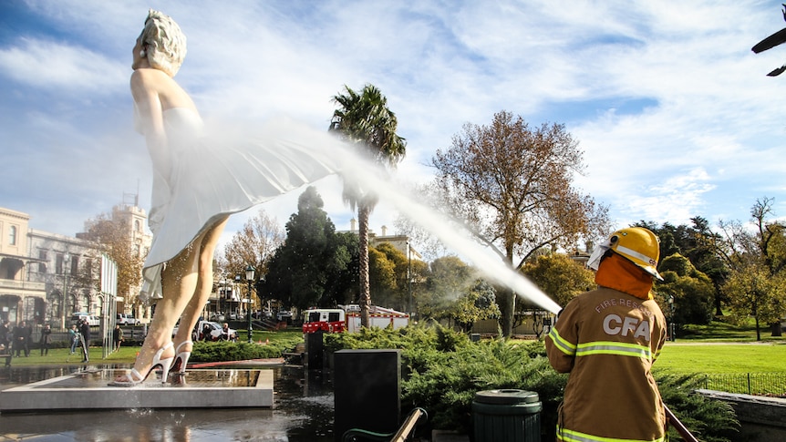The Bendigo Fire Station crew help hose down Marilyn Monroe as part of the agreement to wash the statue while on loan.