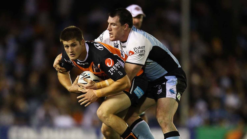 All wrapped up ... Blake Ayshford (L) is tackled by Cronulla's Paul Gallen.