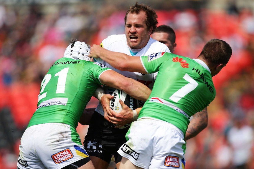 Tight tussle ... Clint Newton takes on the Raiders defence