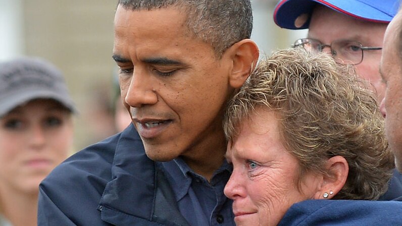 US president Barack Obama comforts superstorm Sandy victim Dana Vanzant as he visits a neighbourhood in Brigantine, New Jersey.