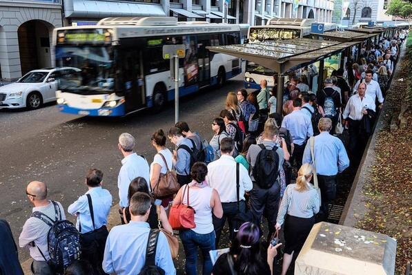 People lining up for buses in the CBD