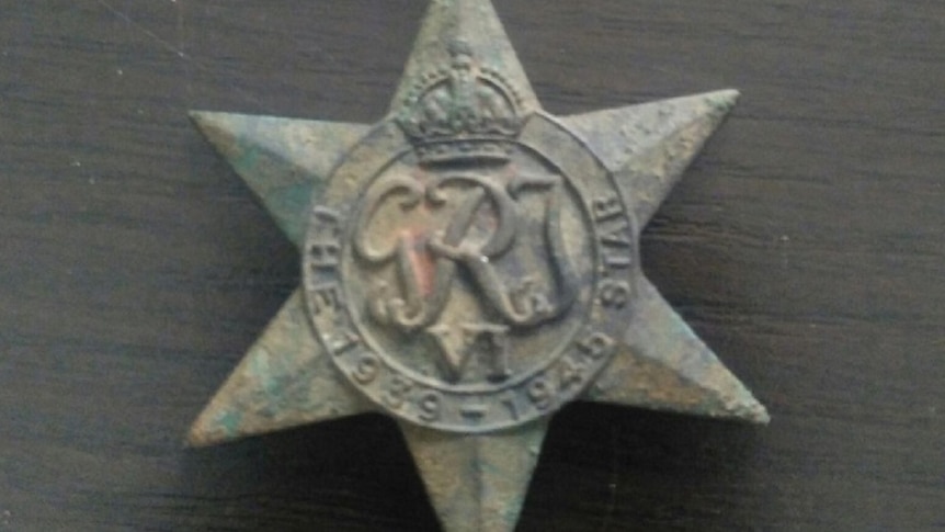 Green and rusted star-shaped medal