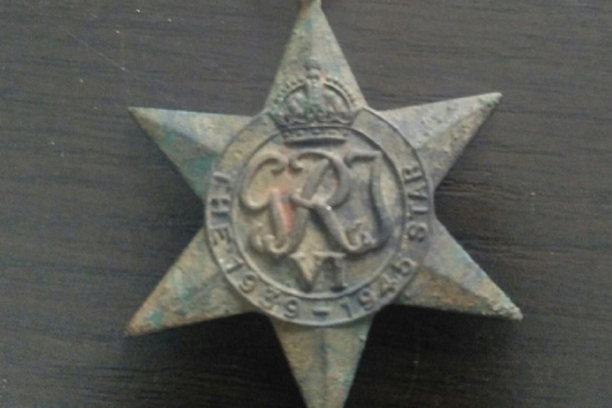 Green and rusted star-shaped medal
