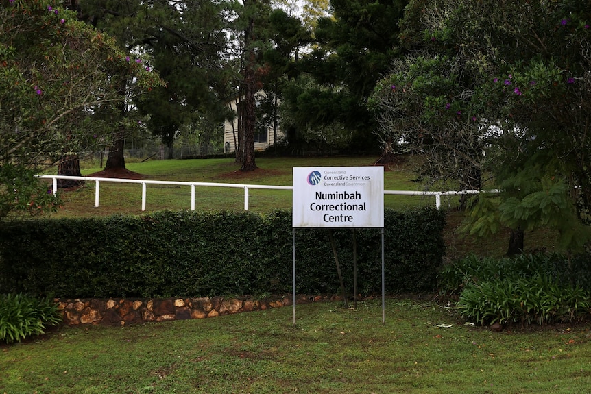 A sign outside a centre surrounded by trees.