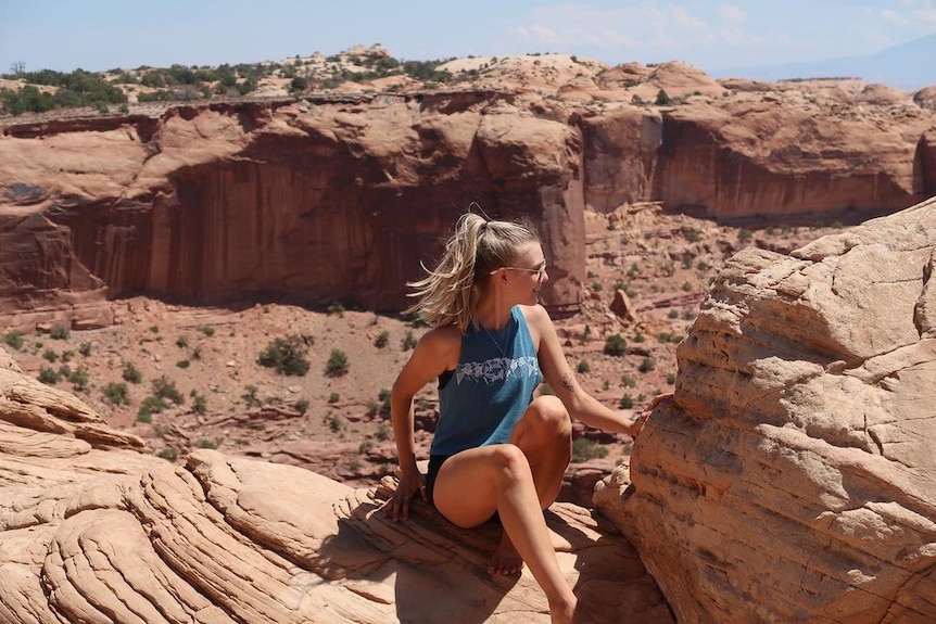 Gabby Petito poses on a cliff