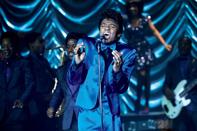 Actor Chadwick Boseman channels singer James Brown he is wearing a blue silk suit