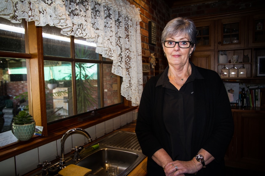 Jennifer Lewis standing next to the window and sink in the kitchen