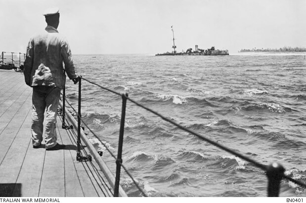 A seaman onboard HMAS Sydney looks out at the wreckage of the Emden.