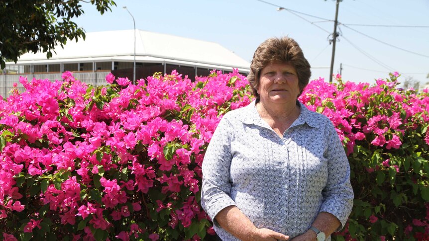Kaylene Reynolds stands in front of flowers at Bryan Park