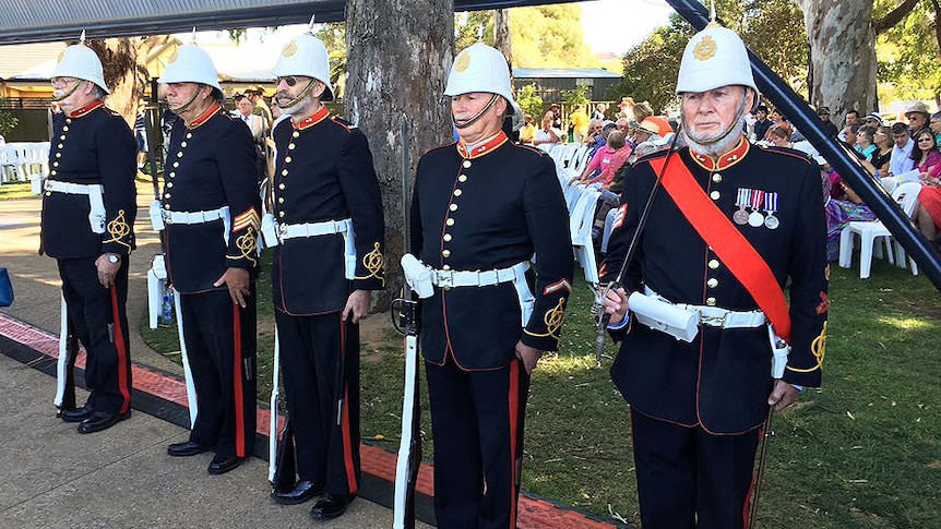 Men in traditional uniform stand straight during the Proclamation Day ceremony.