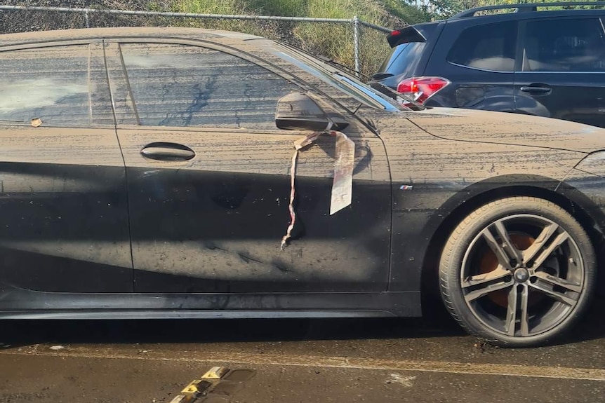 A muddied car after being submerged by floodwaters