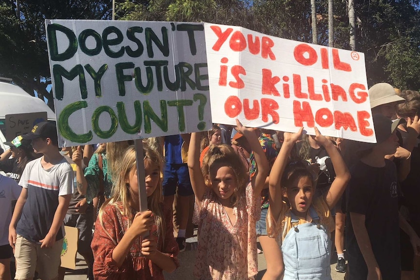 A crowd of people gather behind a banner that says "this generation will not wait"